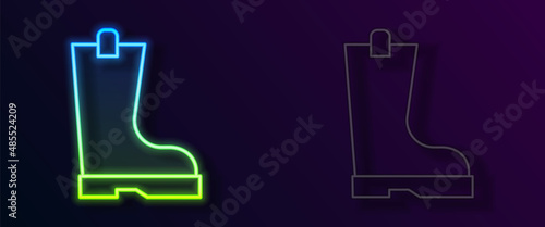 Glowing neon line Waterproof rubber boot icon isolated on black background. Gumboots for rainy weather, fishing, gardening. Vector