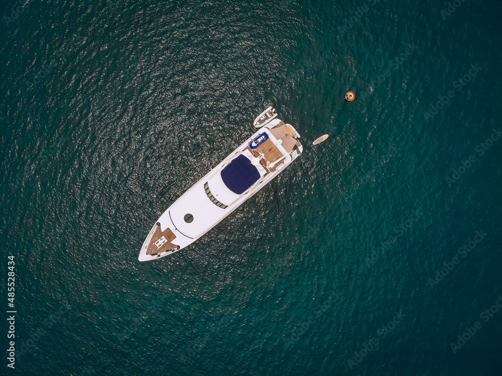 Top view of the luxurious yacht in the vast blue sea; lifestyle concept. Top view of the luxurious yacht in the vast blue sea; lifestyle concept.