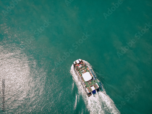 Bird eye view of the holiday cruiser with many deck-chairs on beard  deck, flecks on the water. Cruise concept. © Semachkovsky 