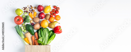 Healthy food background. Healthy vegan food in paper bag vegetables and fruits on white. Shopping food supermarket, food delivery, clean eating, vegetarian сoncept. Copy space