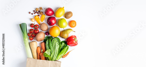 Healthy food background. Healthy vegan food in paper bag vegetables and fruits on white. Shopping food supermarket, food delivery, clean eating, vegetarian concept. Copy space