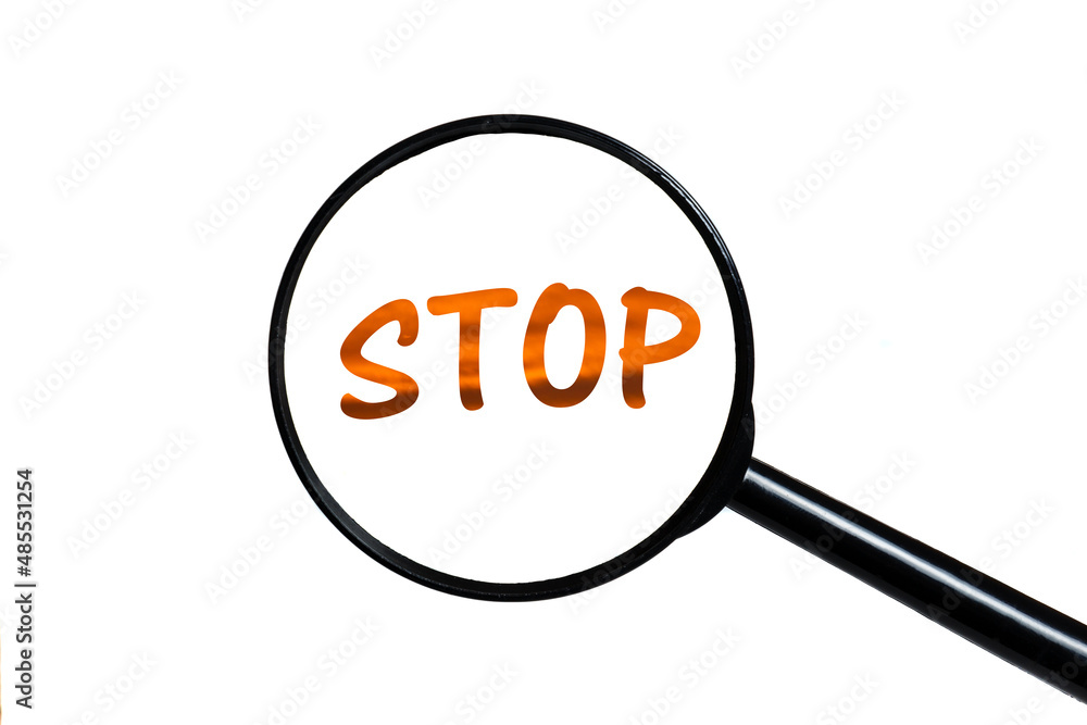 word stop and magnifying glass on white background. word stop and magnifying glass on white background.