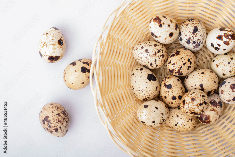 quail eggs in a shell in a basket on a light background quail eggs in a shell in a basket on a light background