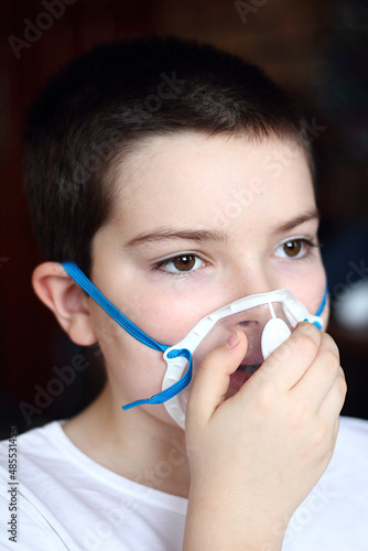 A boy with an oxygen mask