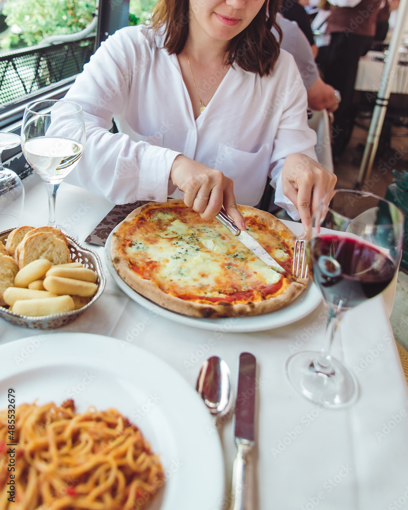 crop picture of woman in restaurant eating pizza drinking wine crop picture of woman in restaurant eating pizza drinking wine