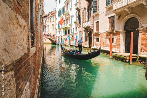Italy, Venice - May 25, 2019: people at gondola taking tour by canal © phpetrunina14