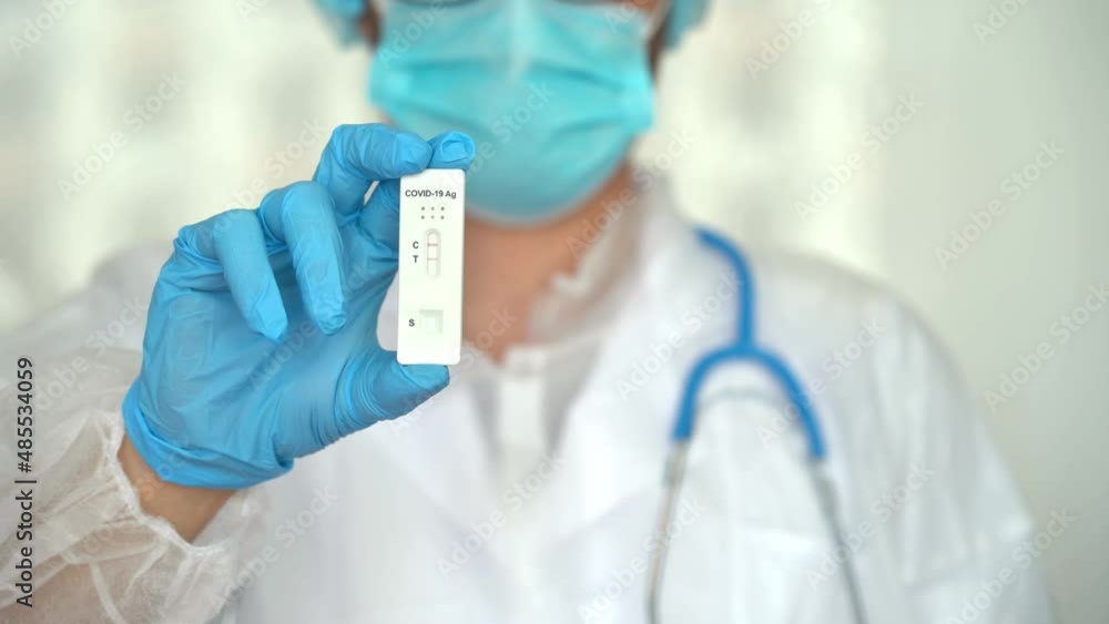 Hand in protective glove holds rapid antigen test for covid-19. Quick swab method to test Coronavirus. PCR Hand in protective glove holds rapid antigen test for covid-19. Quick swab method to test Coronavirus. PCR