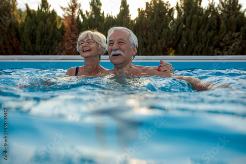 Senior couple enjoying pool time.