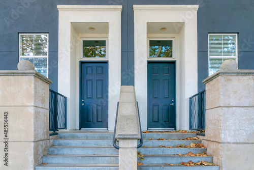 Two blue front doors with white doorframes and transom windows at San Jose bay area, California