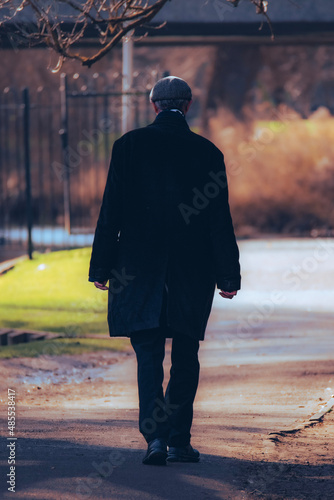 mysterious man walking in park