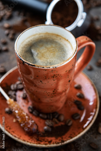 Coffee drink in mug, coffee beans and portafilter