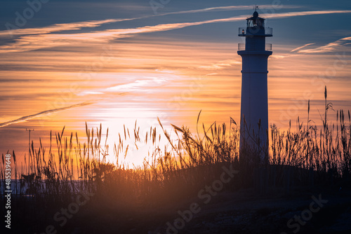View of the lighthouse of Torrox at sunset, is a lighthouse that is located on the coast of the municipality of Torrox, Malaga, Andalusia, Spain.