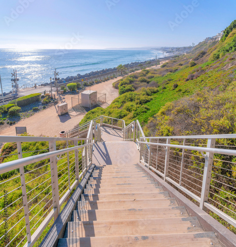 Staircase on a slope with a view of the train tracks and beach at San Clemente, California