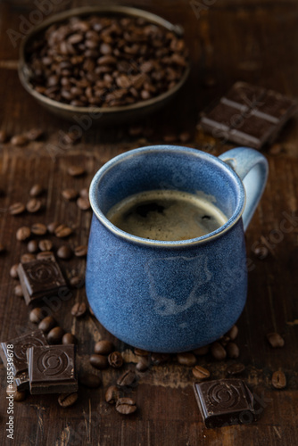 Ceramic cup with coffee on dark background, selective focus