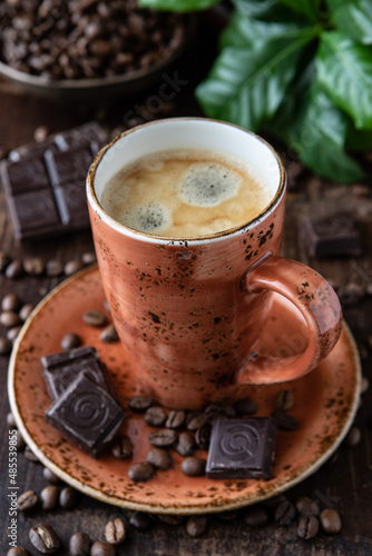 Mug with coffee on on dark wooden background