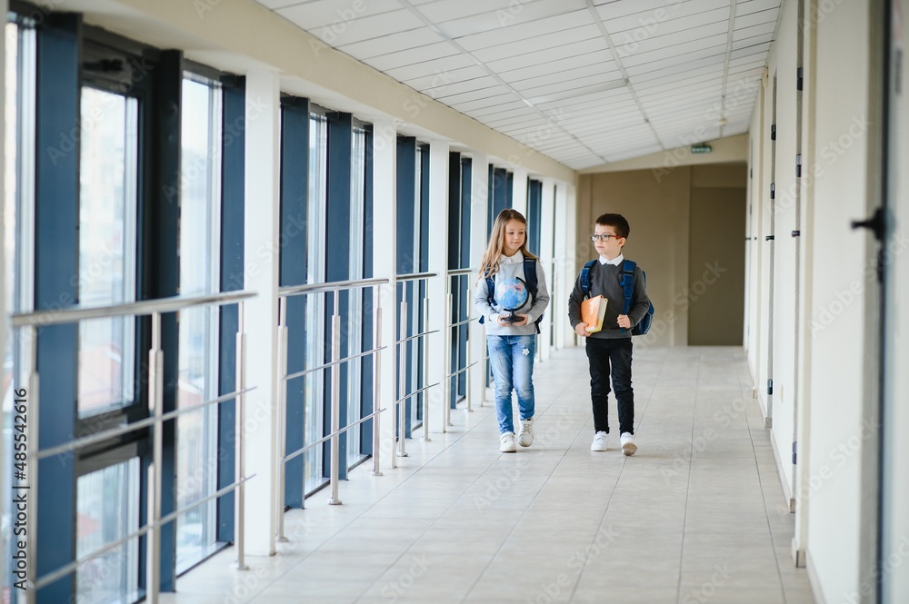 Fototapeta premium Happy school kids in corridor at school