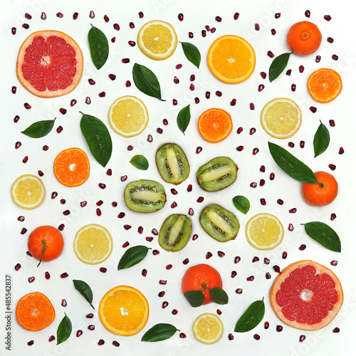 Set from fresh fruits . Fresh slices lemons,mandarins, oranges, grapefruits ,kiwi ,pomegranate seeds isolated on a white background . Healthy food photo . Flat lay , top view