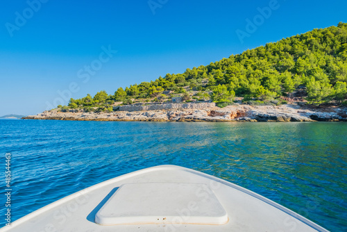 Boat sailing to rocky coast of Murter island in Dalmatia, Croatia