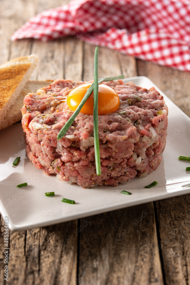Beef steak tartare on rustic wooden table Beef steak tartare on rustic wooden table