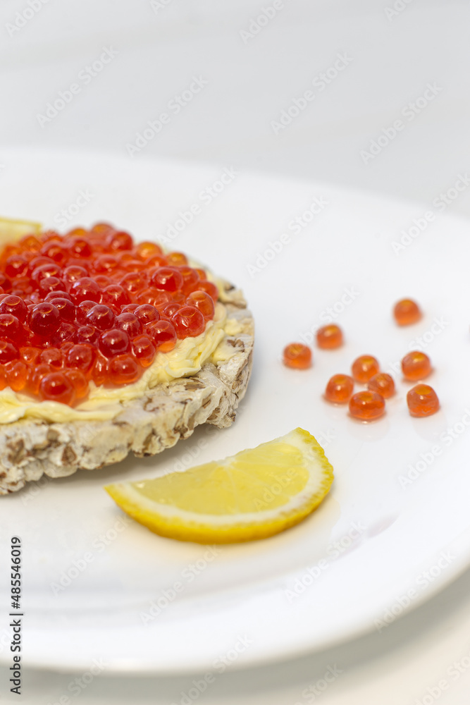 Crispy wheat crackers with red caviar, spread and lemon. Natural Diet Bread Crispy wheat crackers with red caviar, spread and lemon. Natural Diet Bread