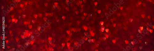 Red hearts, sparkling glitter bokeh background texture. Holiday valentines day lights. Abstract defocused header. Wide screen wallpaper. Panoramic web banner with copy space for design