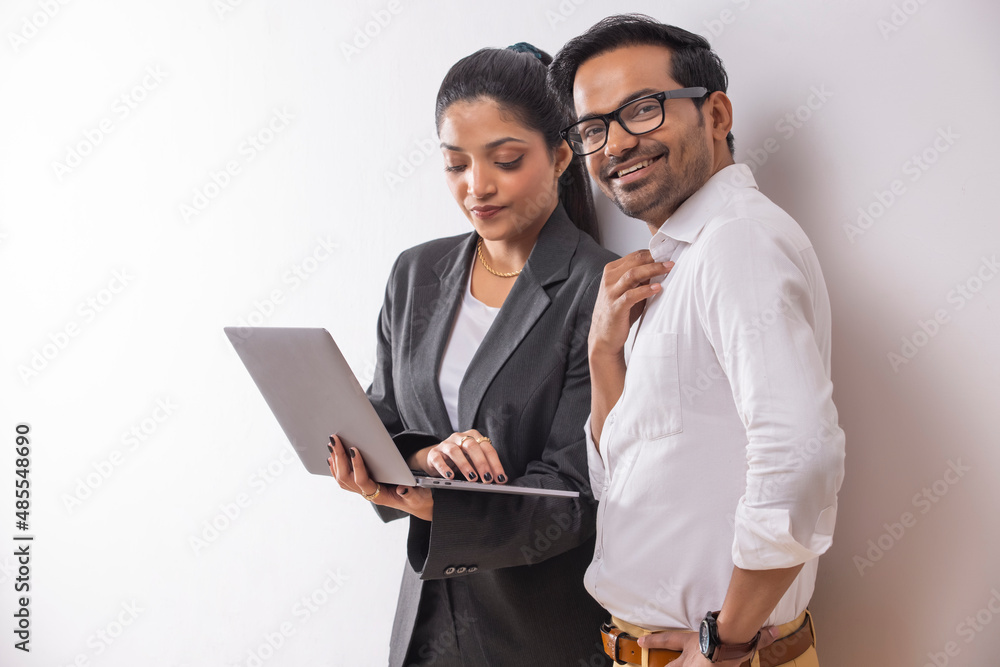 Office colleagues together doing office work using laptop Office colleagues together doing office work using laptop
