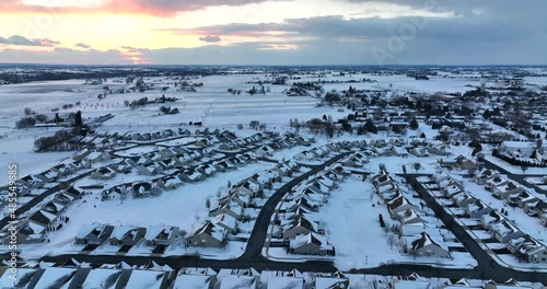 Town covered in heavy winter snow. Aerial of homes in residential community at sunset. Aerial. photo