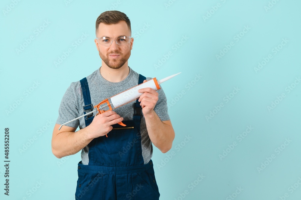Portrait of a friendly worker. Isolated on blue Portrait of a friendly worker. Isolated on blue