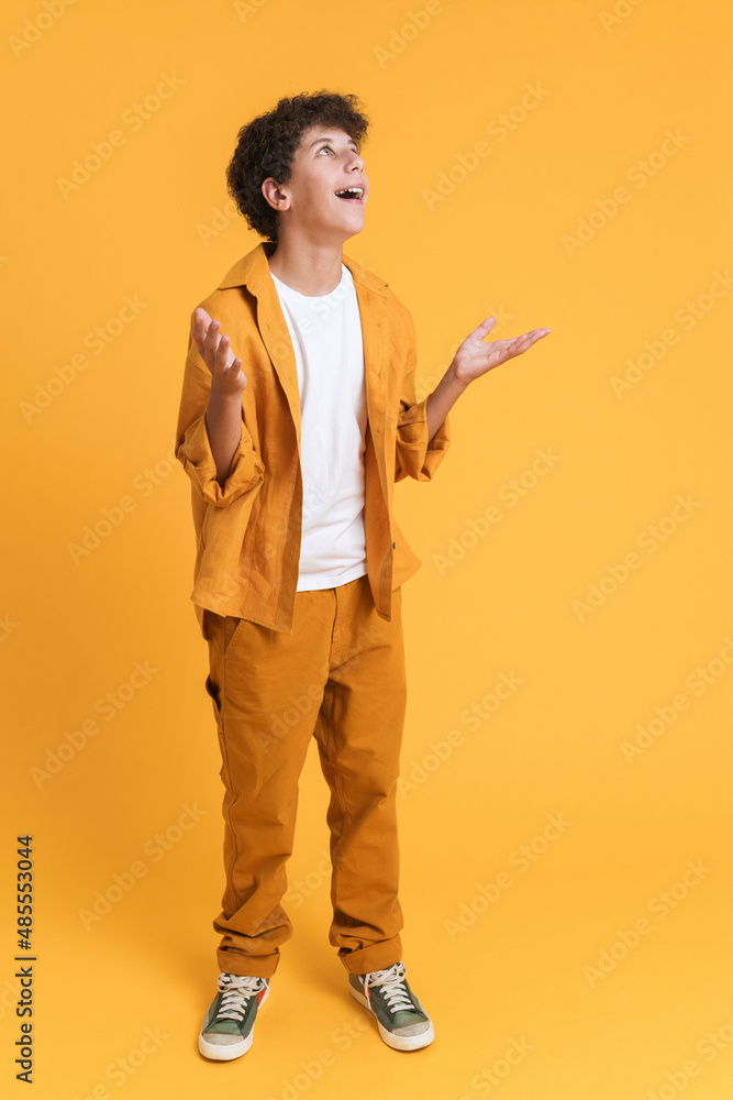 Fototapeta premium White boy wearing suit gesturing and smiling at camera