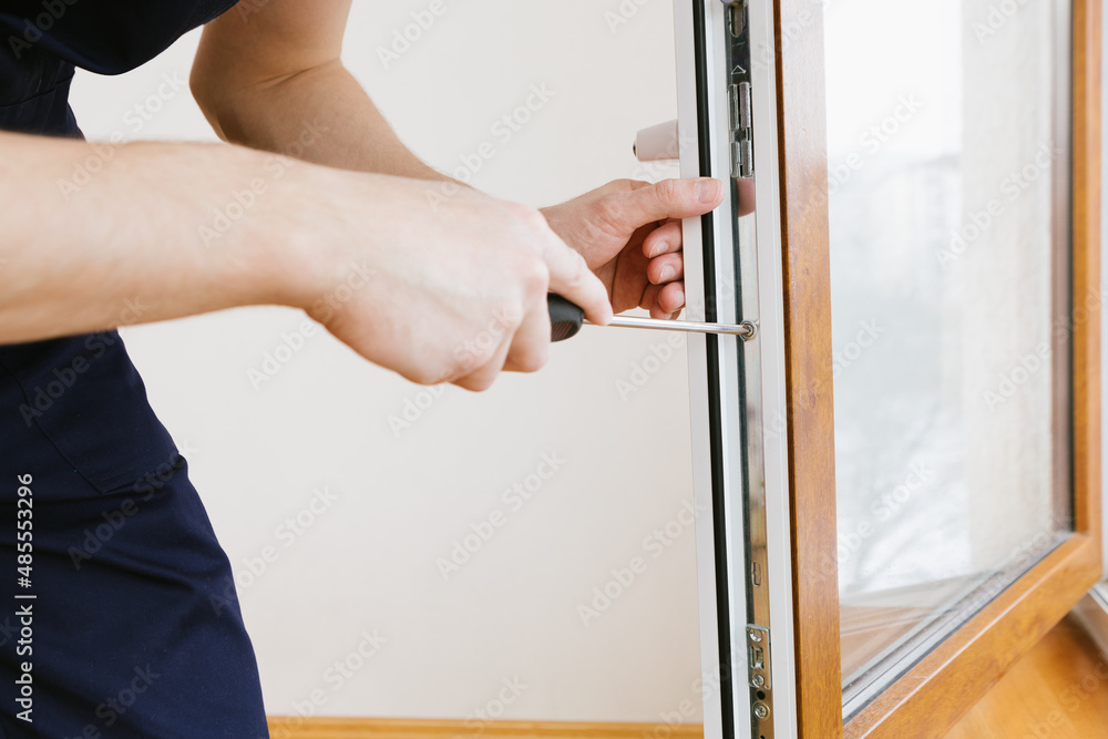 The worker installing and checking window in the house The worker installing and checking window in the house