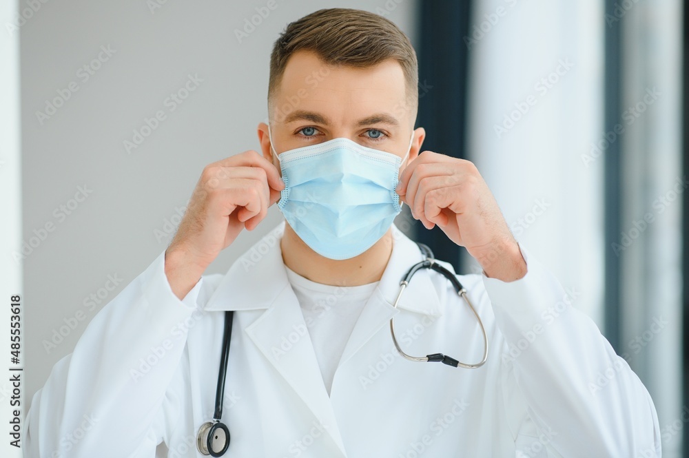 doctor man puts on a protective mask doctor man puts on a protective mask