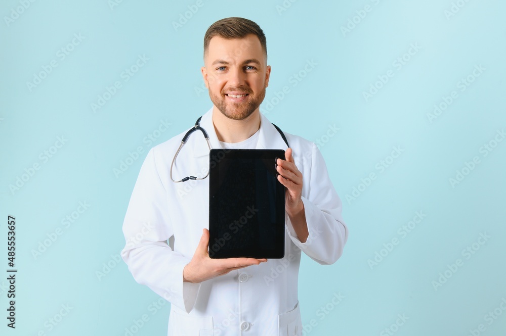 closeup of showing a tablet holding in hands by a male doctor who has a pretty smiley. closeup of showing a tablet holding in hands by a male doctor who has a pretty smiley.