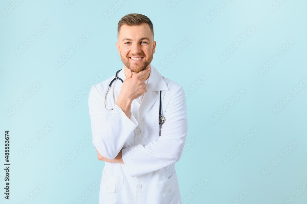 Portrait of a smiling doctor on a blue background. Healthcare concept. Portrait of a smiling doctor on a blue background. Healthcare concept.