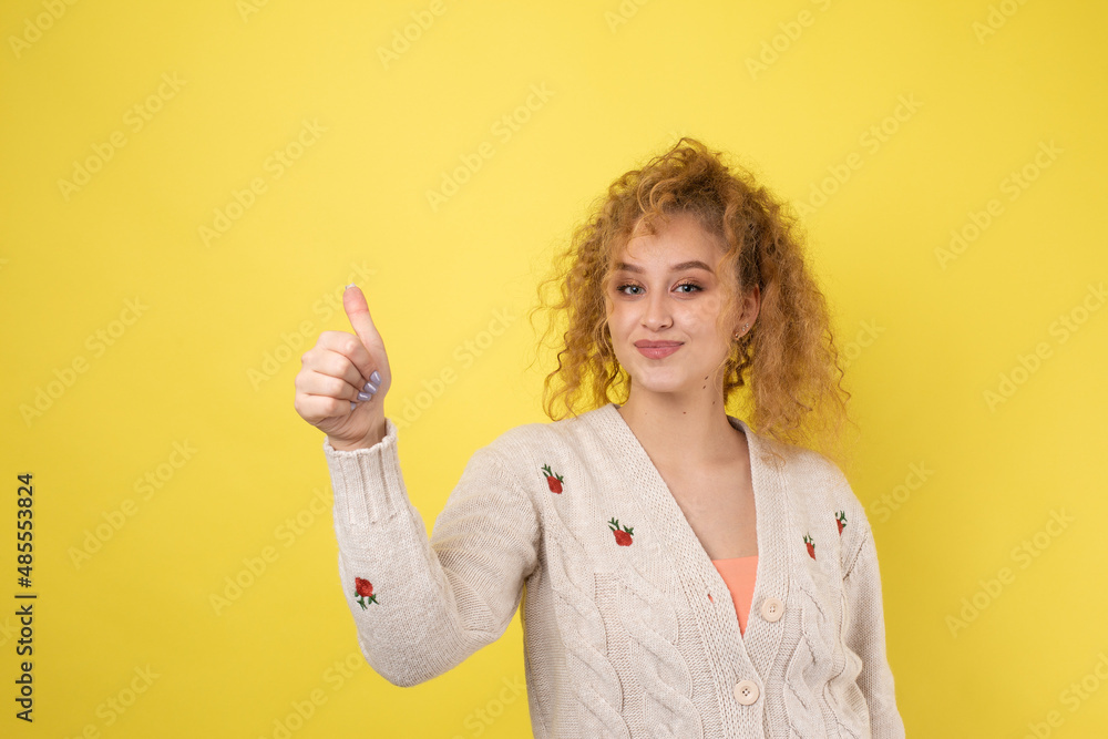 Close-up portrait of attractive surprised girl, showing thumbs up gesture. Success luck concept. Close-up portrait of attractive surprised girl, showing thumbs up gesture. Success luck concept.