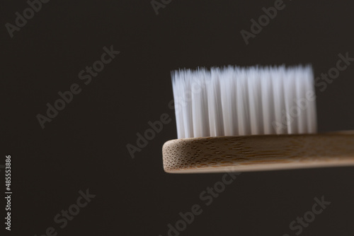 Set of ECO friendly wooden bamboo toothbrushes. Save the planet or NO plastic concept. Isolated on grey background.