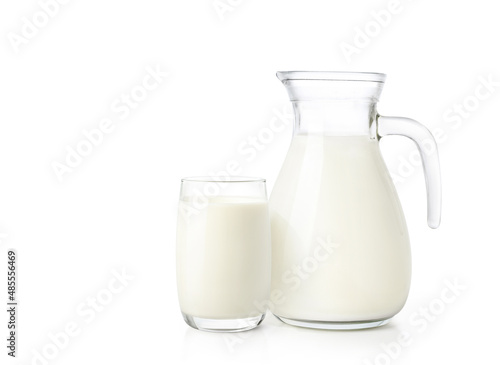 Glass and jug of fresh milk isolated on white background.