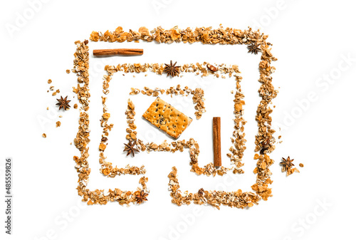 maze or labyrinth made out of cereals with a cookie in the middle isolated over white background, way to healthy eating concept photo