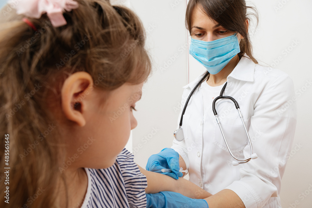 vaccination of children. Doctor examining a child in a hospital vaccination of children. Doctor examining a child in a hospital