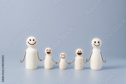 Wooden figures of smiley family members.  Concept of family relationship  big family  happyness  family care concept.