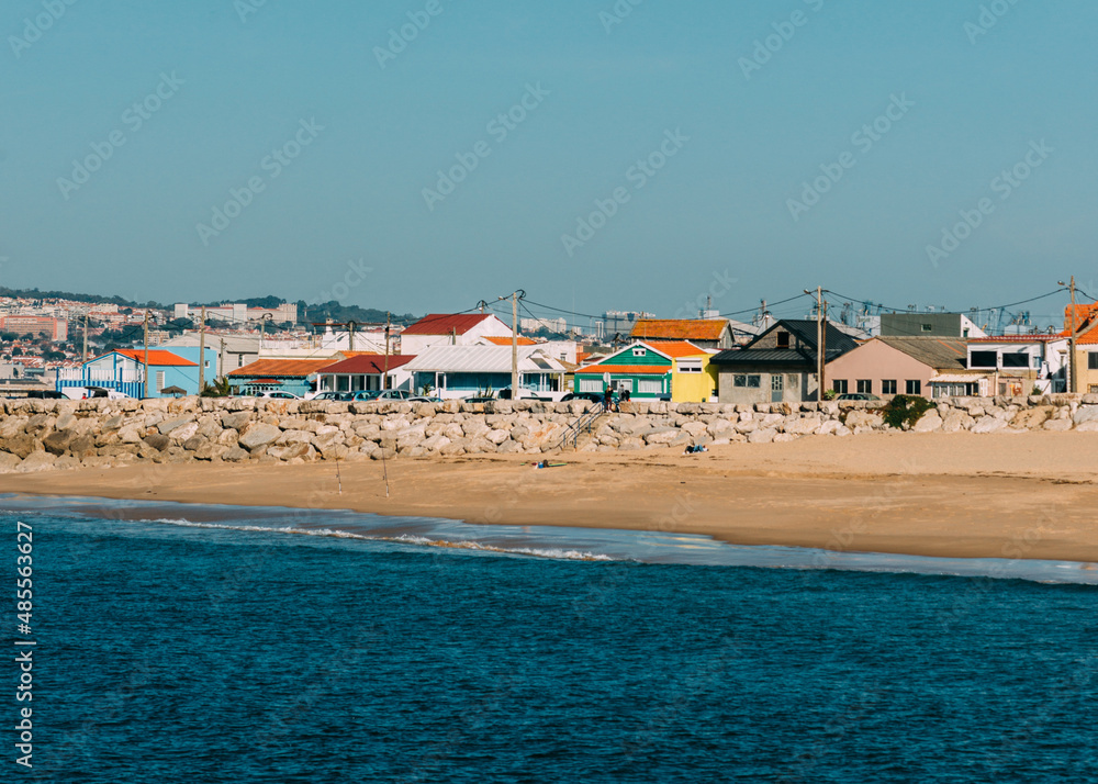 Cova Vapor, Portugal - February 6, 2022: Colourful fishing houses in Cova Vapor, Lisbon Region, Portugal