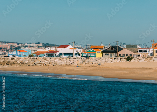 Cova Vapor, Portugal - February 6, 2022: Colourful fishing houses in Cova Vapor, Lisbon Region, Portugal