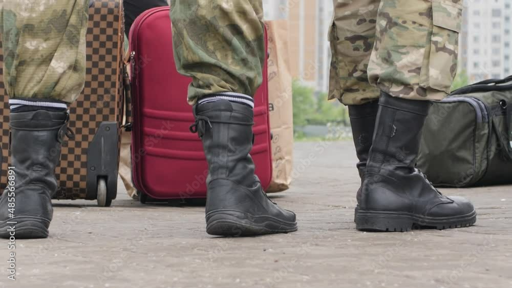 Close-up of soldier boots with bags. Recruits before transportation to camp Close-up of soldier boots with bags. Recruits before transportation to camp
