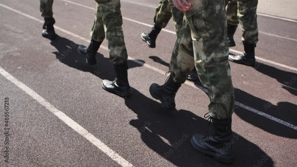 Soldiers marching in a row. Young soldiers marching in slow motion Soldiers marching in a row. Young soldiers marching in slow motion