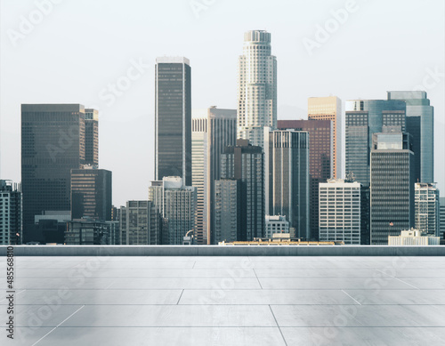 Empty concrete rooftop on the background of a beautiful Los Angeles city skyline at sunset, mock up
