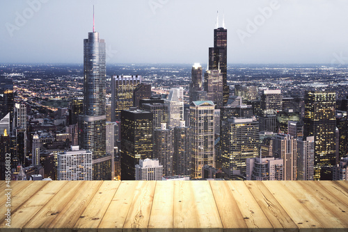 Table top made of wooden dies with Chicago city view at dusk on background  template