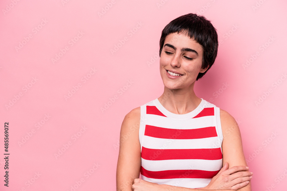 Young caucasian woman isolated on pink background smiling confident with crossed arms. Young caucasian woman isolated on pink background smiling confident with crossed arms.