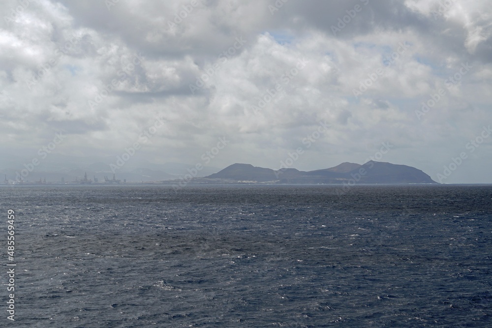 Atlantic Ocean. Canary Islands view from open water. Clouds. Haze.