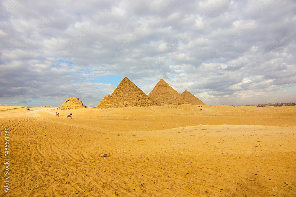 The Great Pyramids of Giza in the Sahara desert (three pyramids, known as Pyramids of Queens, on the front side; next in order from the left: the Pyramid of Menkaure, Khafre and Khufu), Cairo, Egypt