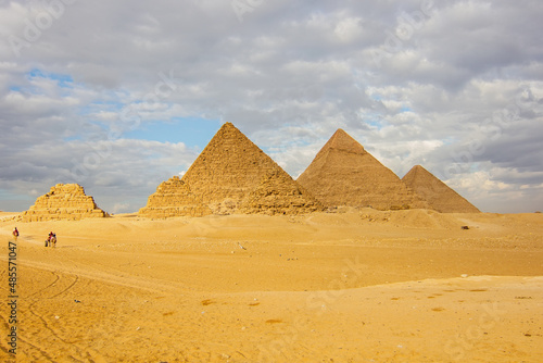 The Great Pyramids of Giza in the desert (three small pyramids, known as Pyramids of Queens, on the front side; next in order from the left: the Pyramid of Menkaure, Khafre and Khufu), Cairo, Egypt