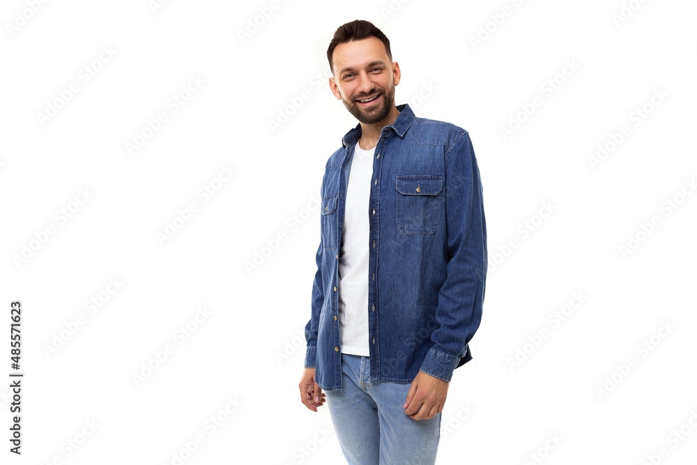 young stylish man with a beard in a denim shirt and a white t-shirt looking at the camera on a white background young stylish man with a beard in a denim shirt and a white t-shirt looking at the camera on a white background